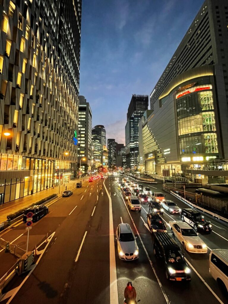 Umeda district in Osaka at night, illuminated by colorful lights and surrounded by towering modern buildings