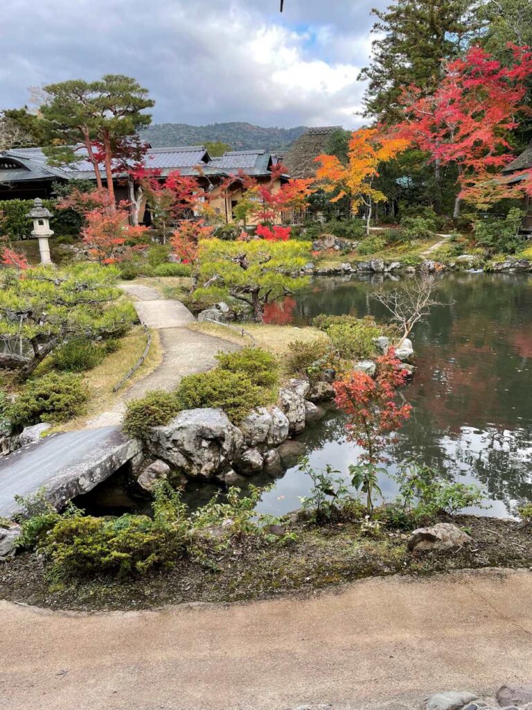 Isuien Garden in Nara featuring a tranquil pond, traditional landscaping, and views of surrounding temples