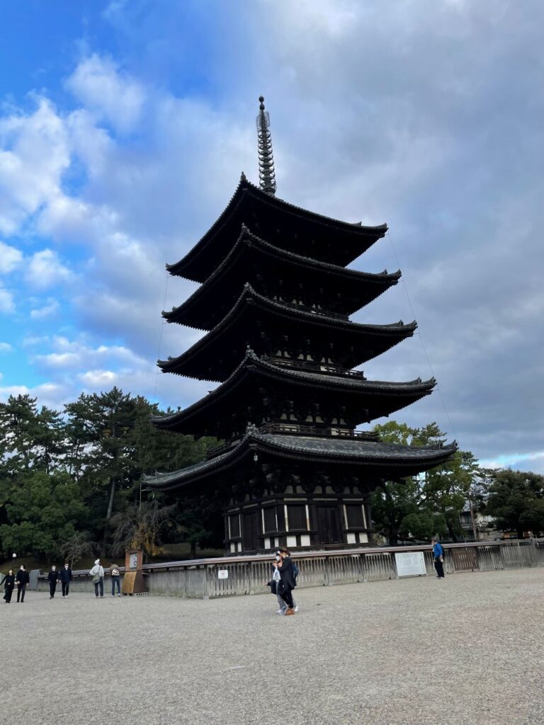 Traditional Japanese temple architecture surrounded by lush greenery in Nara, Japan