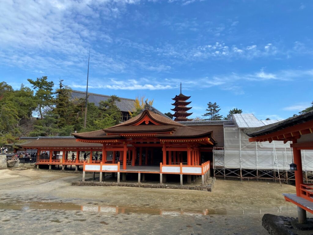 Gojūnotō Five-Story Pagoda on Miyajima Island, Japan, standing beside Toyokuni Shrine against a backdrop of lush green hills