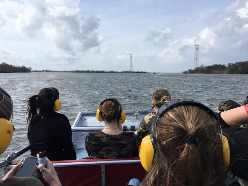 tourists exploring Louisiana Swamp Tour on a New Orleans trip.